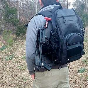 Man carrying mini Striker pistol crossbow in backpack